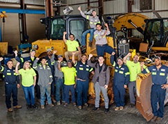 Team among machines in shop
